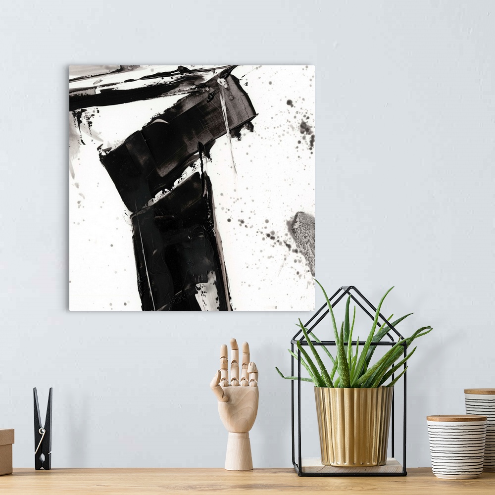 A bohemian room featuring Abstract painting of chaotic wide black  brush strokes with overlaying splatters of black.