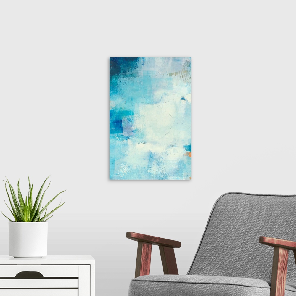 A modern room featuring Vertical abstract painting made in shades of blue with gold accents and lines etched in the thick...