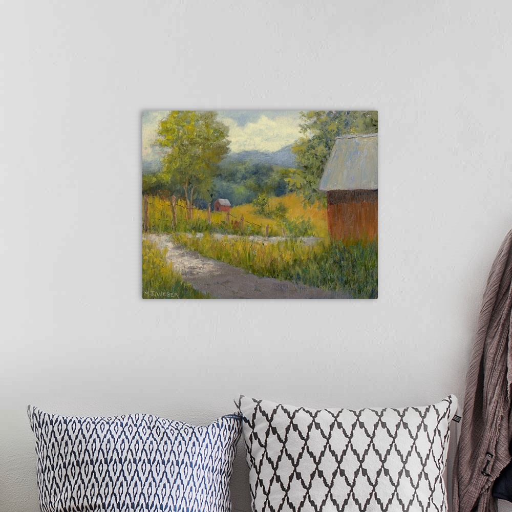 A bohemian room featuring Horizontal painting on a big wall hanging of a small path leading through a green landscape on a ...