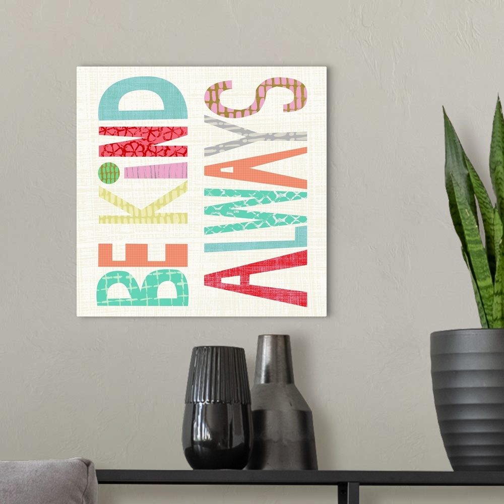 A modern room featuring Children's typography artwork in colorful block letters reading "Be Kind Always."
