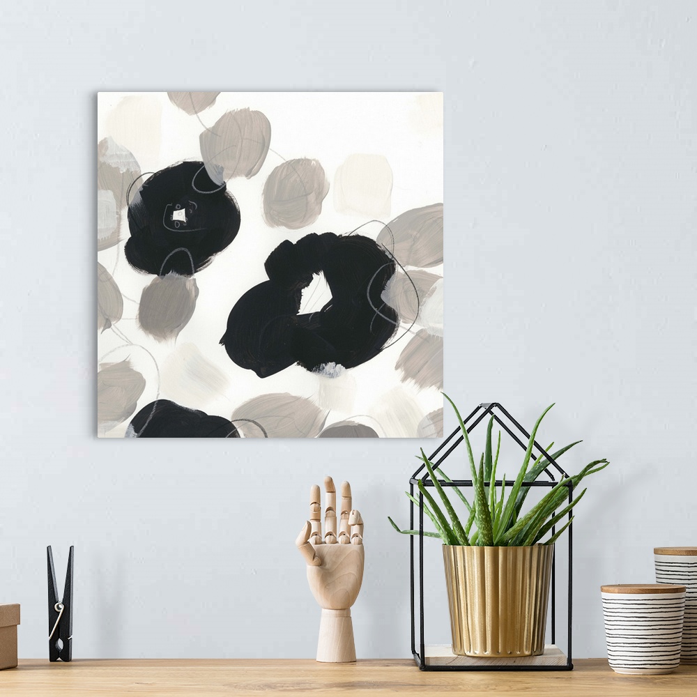 A bohemian room featuring Abstract floral painting with broad black shapes on white and grey.