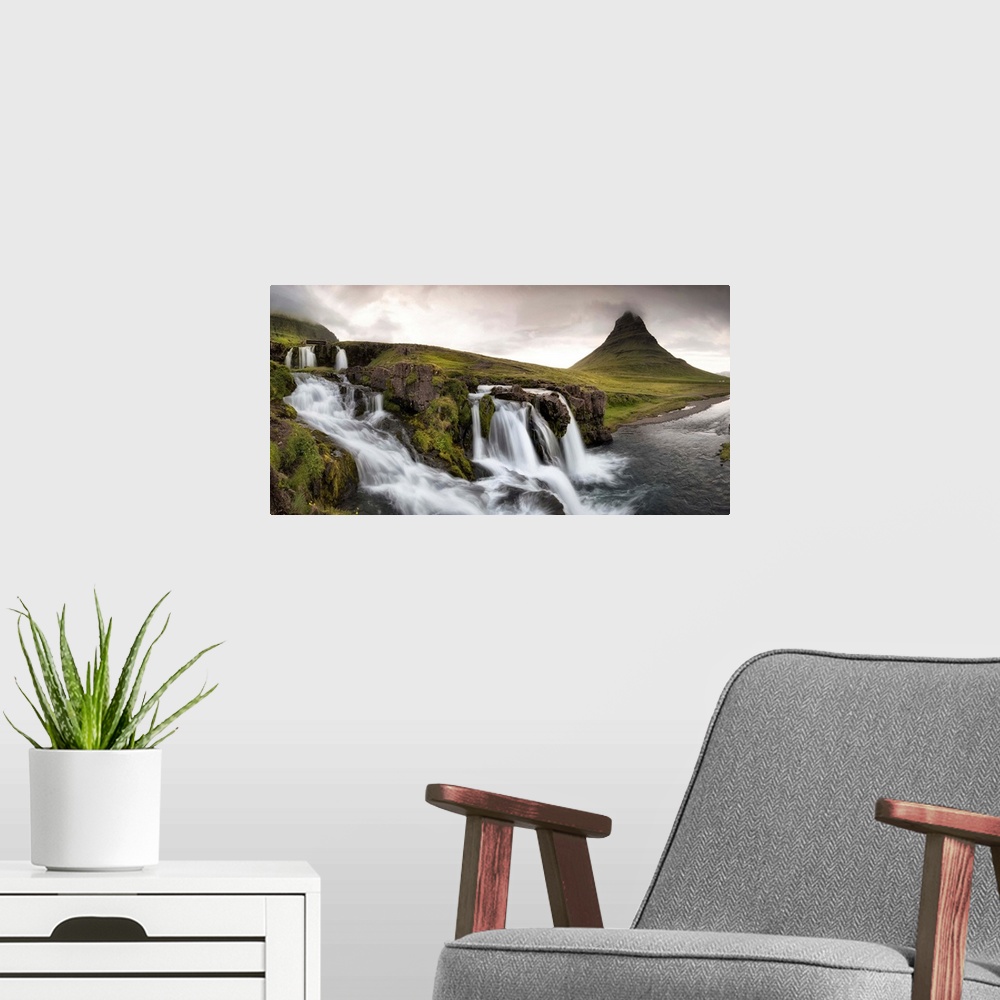 A modern room featuring Stormy clouds gather over tranquil waterfalls in this luscious green landscape photograph.