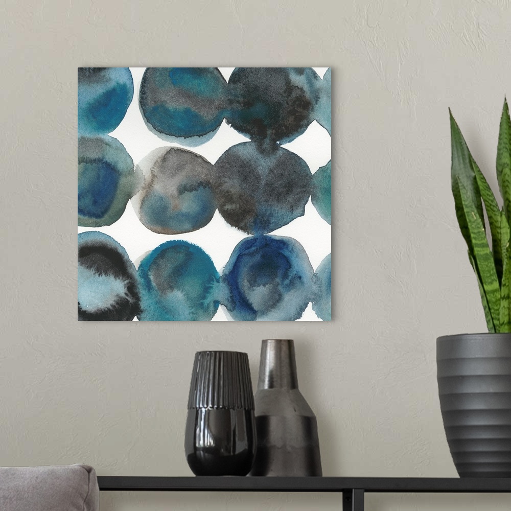 A modern room featuring Square abstract decor with large circles placed in lines made in shades of blue and black.