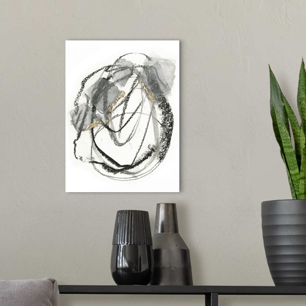 A modern room featuring Abstract painting of black scribbles and gray patches with gold leaf accents on a white background.