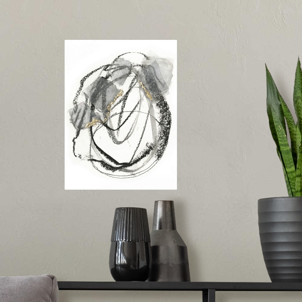 A modern room featuring Abstract painting of black scribbles and gray patches with gold leaf accents on a white background.