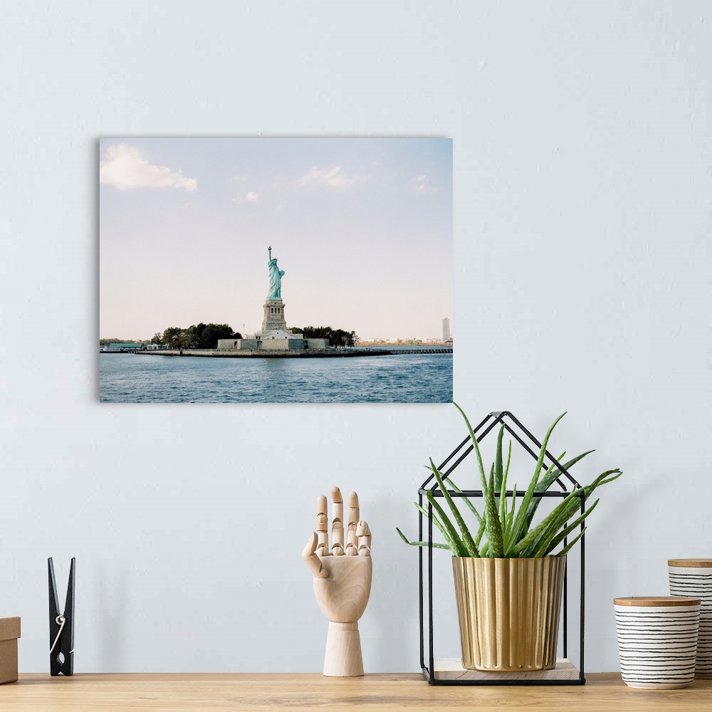 A bohemian room featuring Photograph of the Statue of Liberty taken from across the water, New York City.