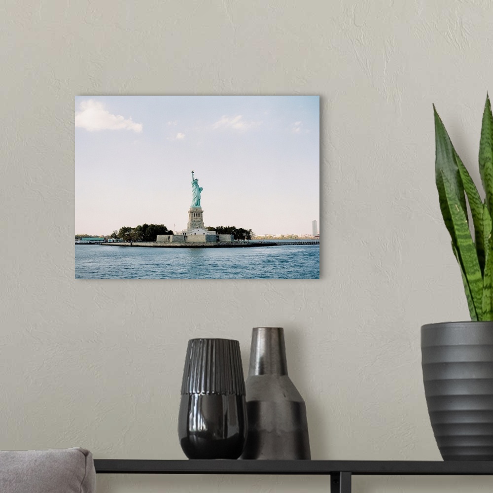 A modern room featuring Photograph of the Statue of Liberty taken from across the water, New York City.