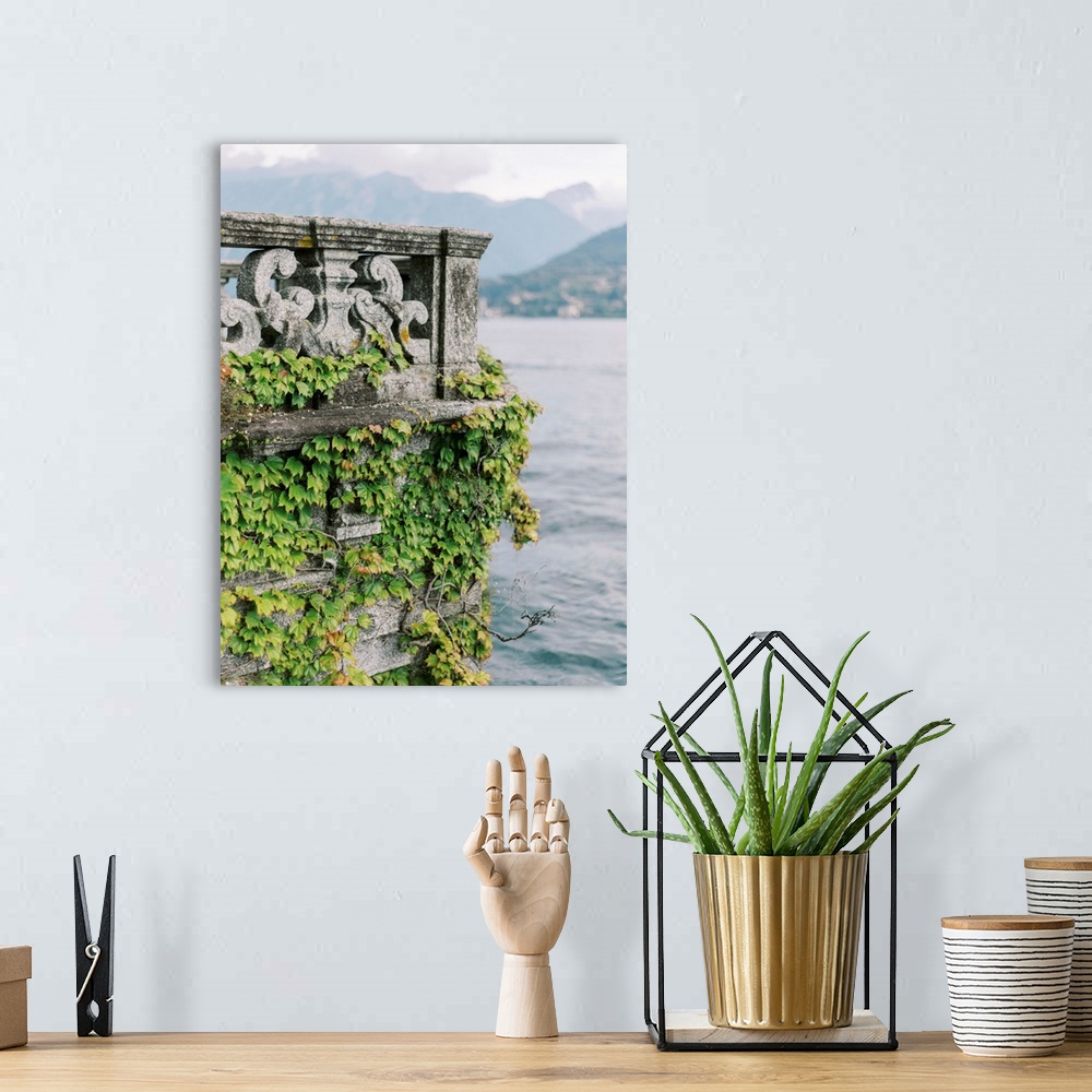 A bohemian room featuring A photograph of an ornate stone balcony covered with ivy on the shore of Lake Como, Italy.