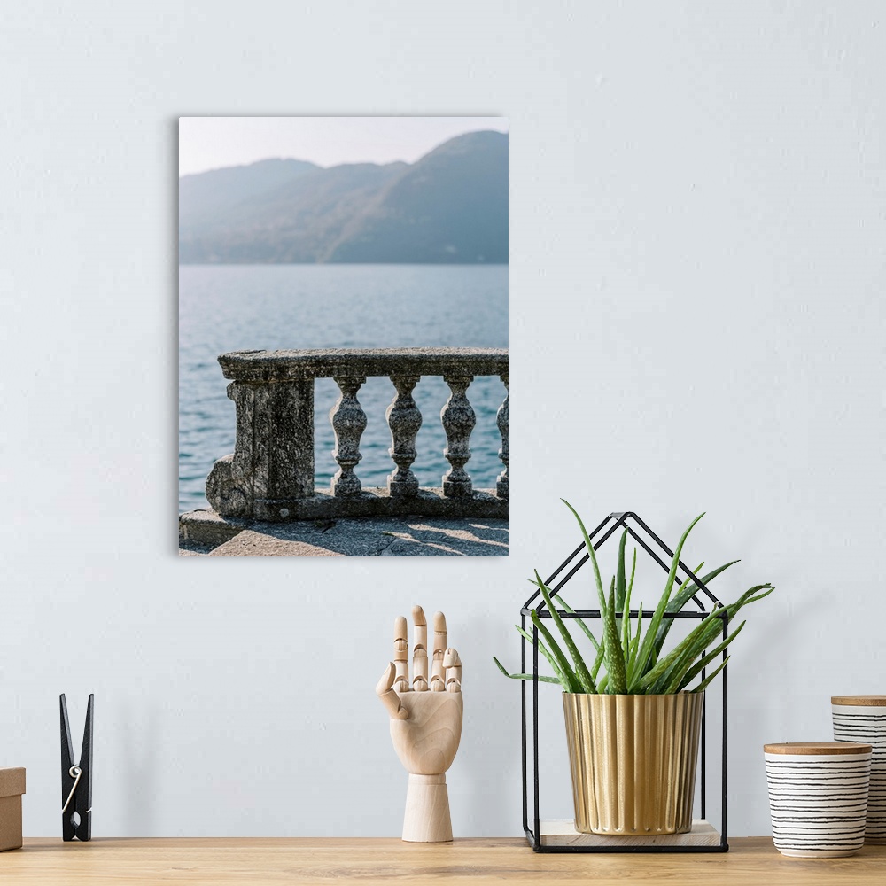 A bohemian room featuring A photograph of an ornate stone balcony on the shore of Lake Como, Italy.