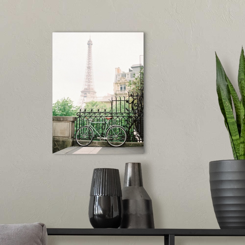 A modern room featuring Photograph of a bicycle leaning against an ornate metal railing with the Eiffel tower in the dist...