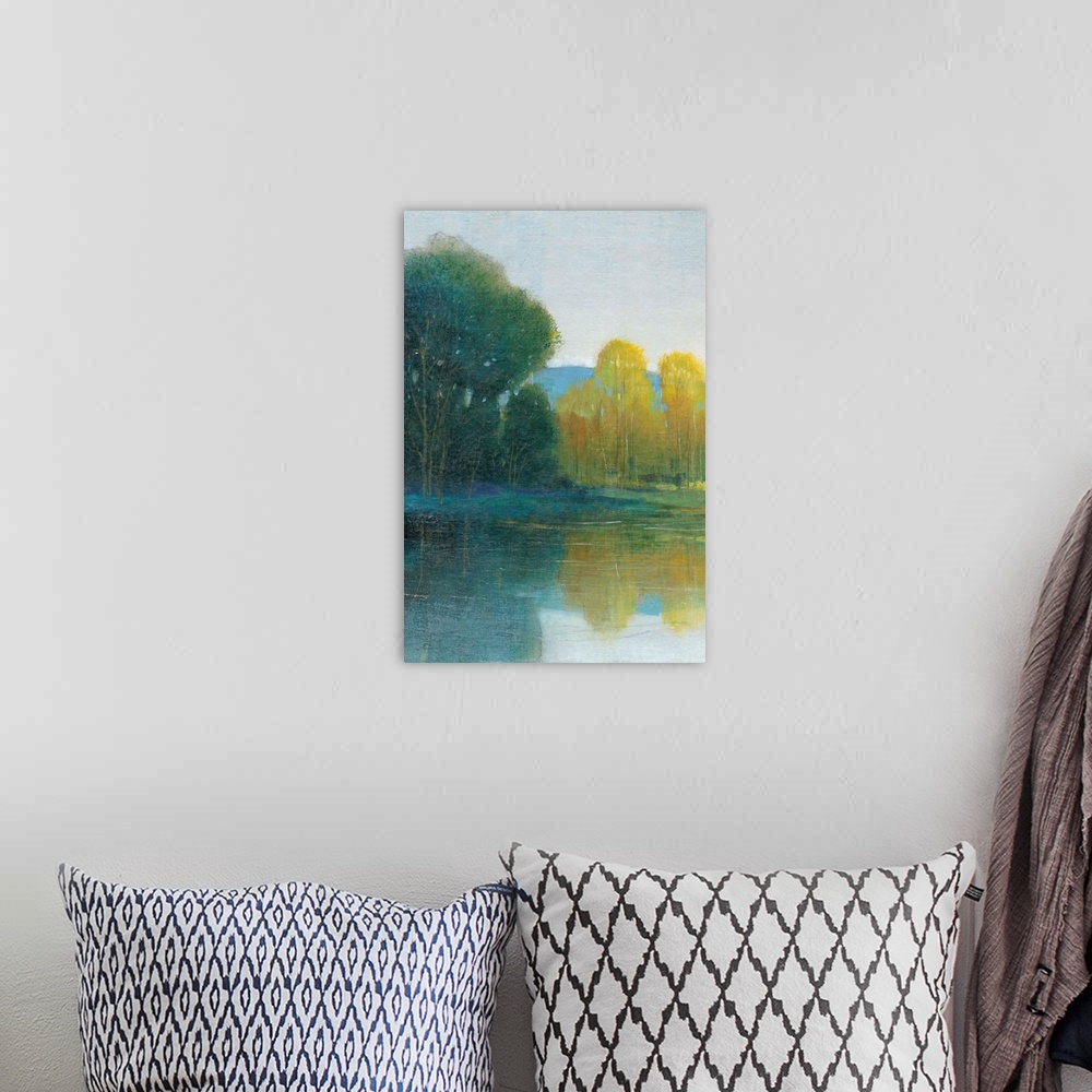 A bohemian room featuring Landscape painting of a calm pond with tall trees along the edge, reflected in the water.