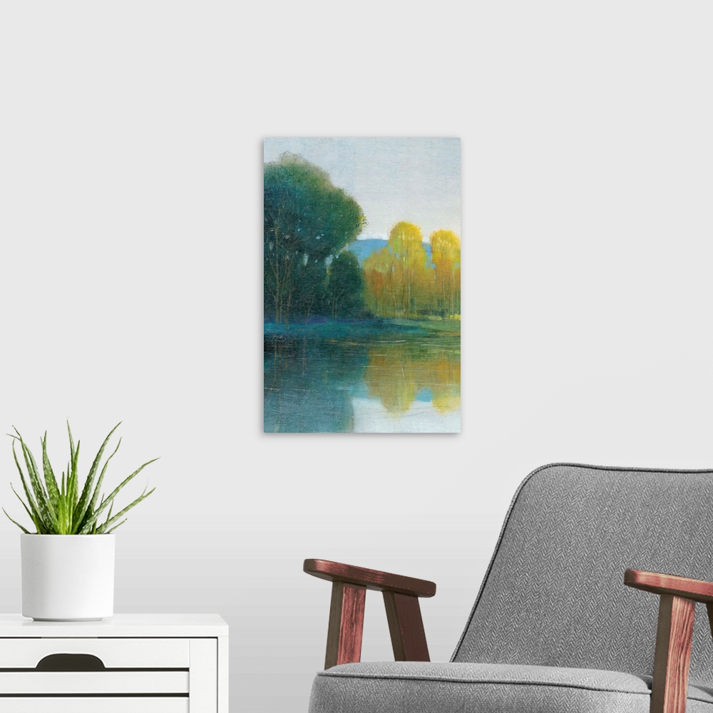 A modern room featuring Landscape painting of a calm pond with tall trees along the edge, reflected in the water.