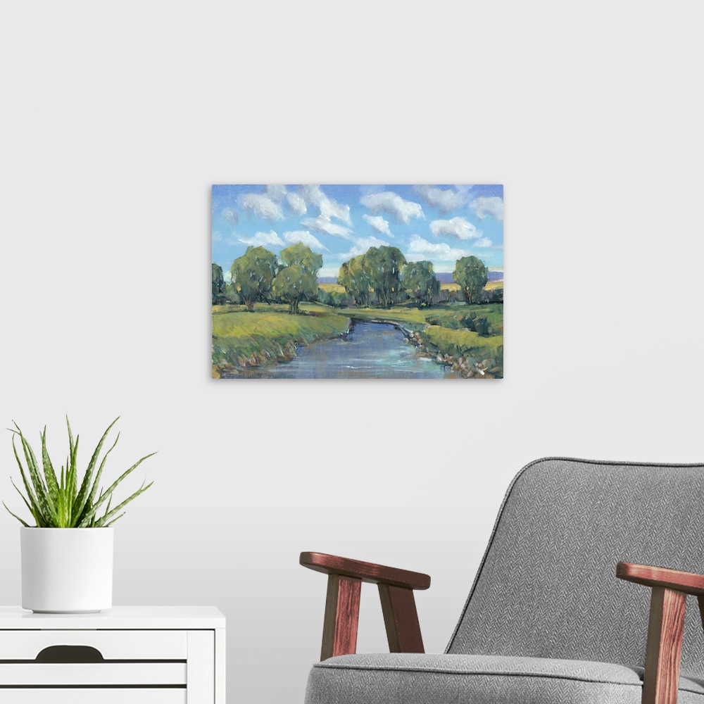 A modern room featuring Contemporary artwork of a stream running through a countryside under a blue summer sky.
