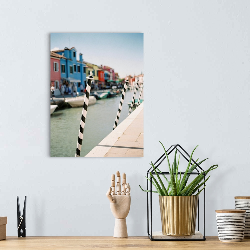 A bohemian room featuring Photograph of the black and white poles used for mooring gondolas, Venice, Italy.