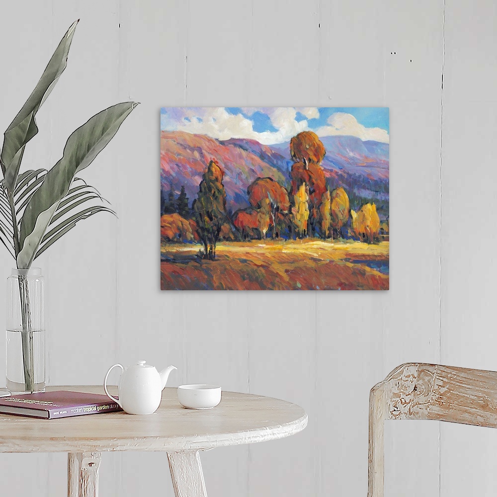 A farmhouse room featuring Contemporary painting of a mountain valley landscape with a grove of trees in the fall.