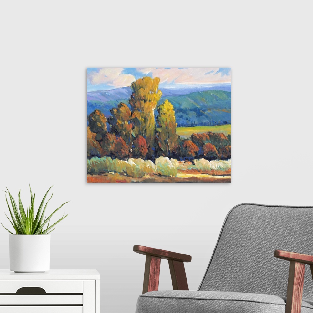 A modern room featuring Contemporary painting of a mountain valley landscape with a grove of trees in the fall.