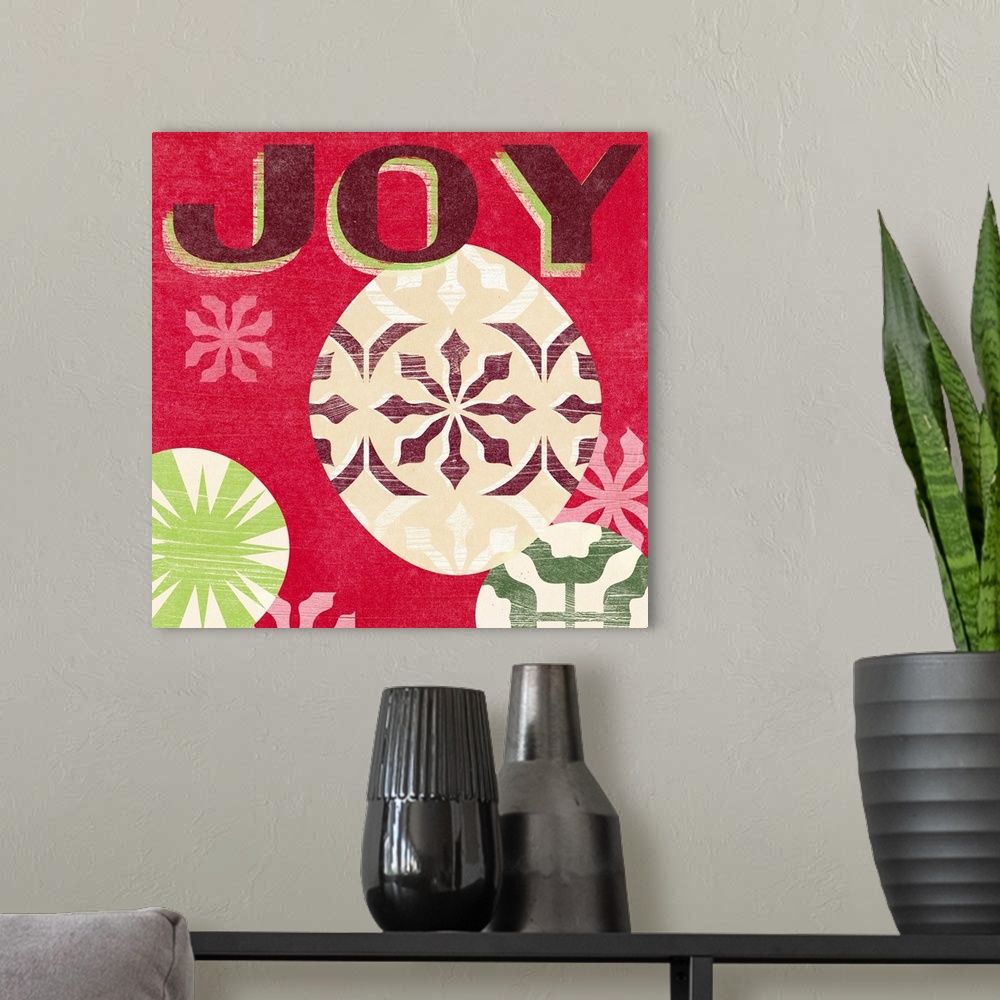 A modern room featuring "Joy" surrounded by holiday ornaments against a red backdrop and overlapping thin white lines tha...