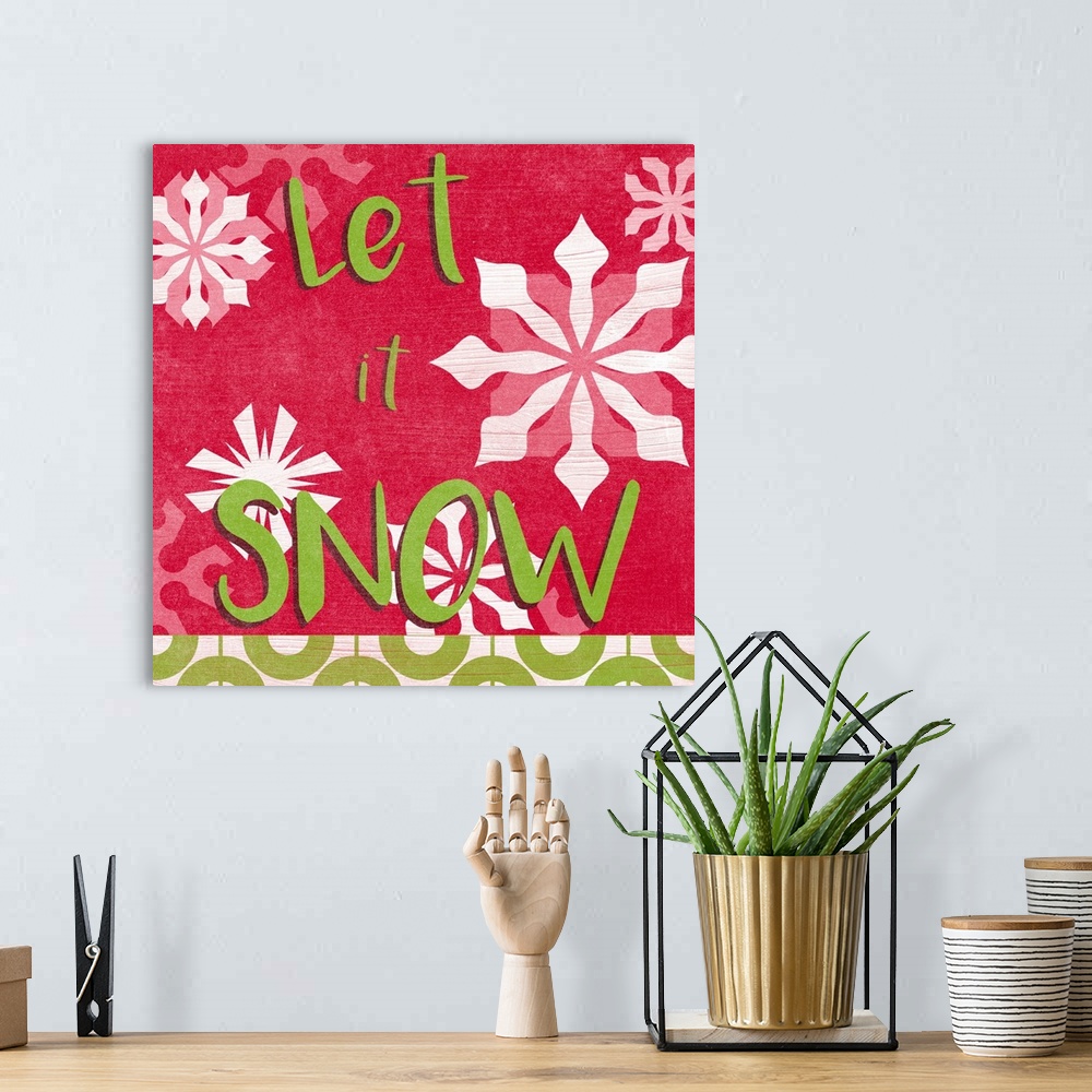 A bohemian room featuring "Let it Snow" surrounded by snowflakes against a red backdrop and overlapping thin white lines th...