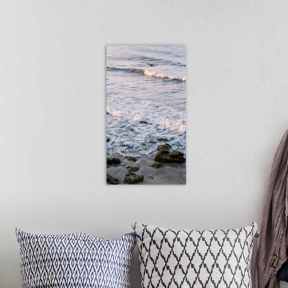 A bohemian room featuring A photograph of gentle waves lapping the beach.