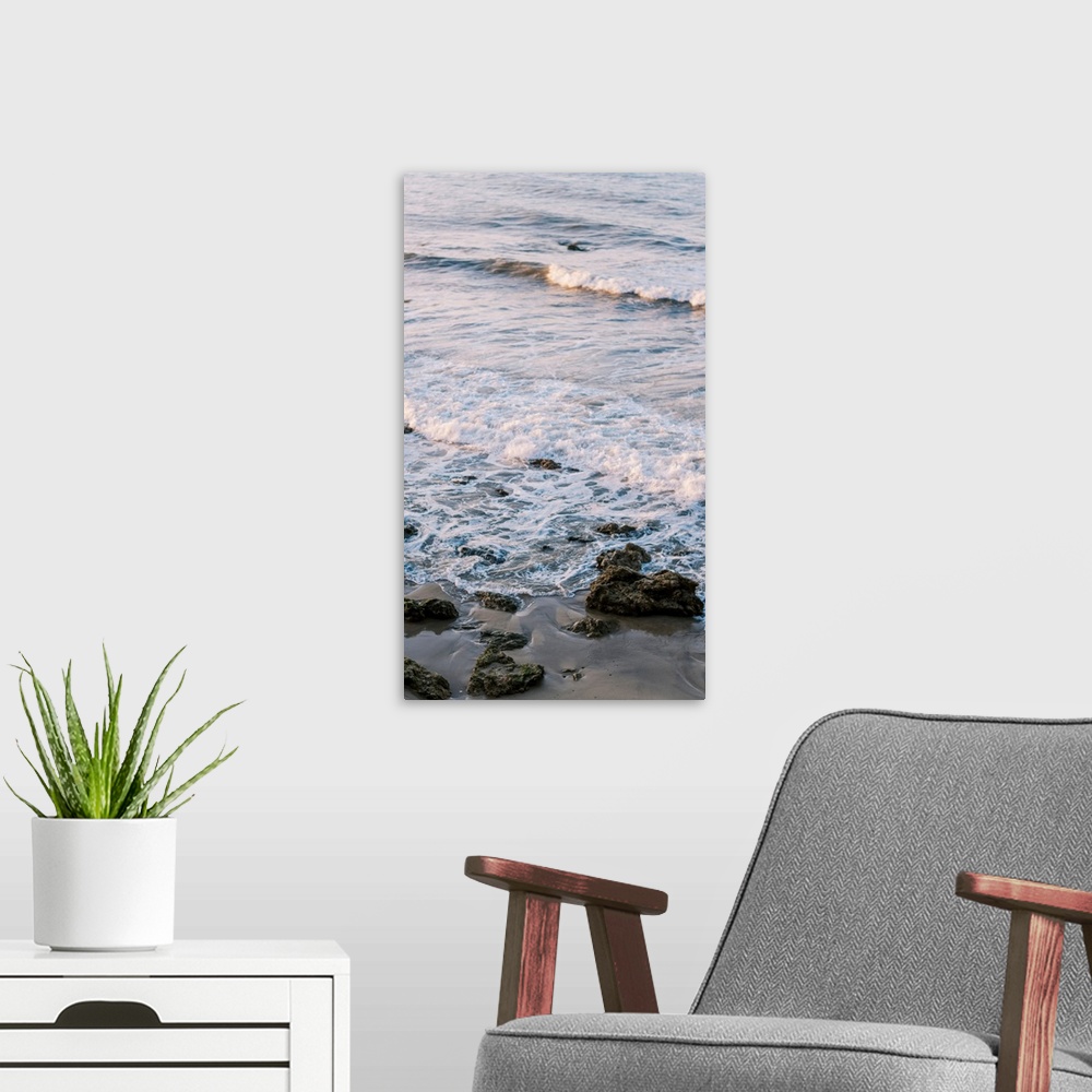 A modern room featuring A photograph of gentle waves lapping the beach.