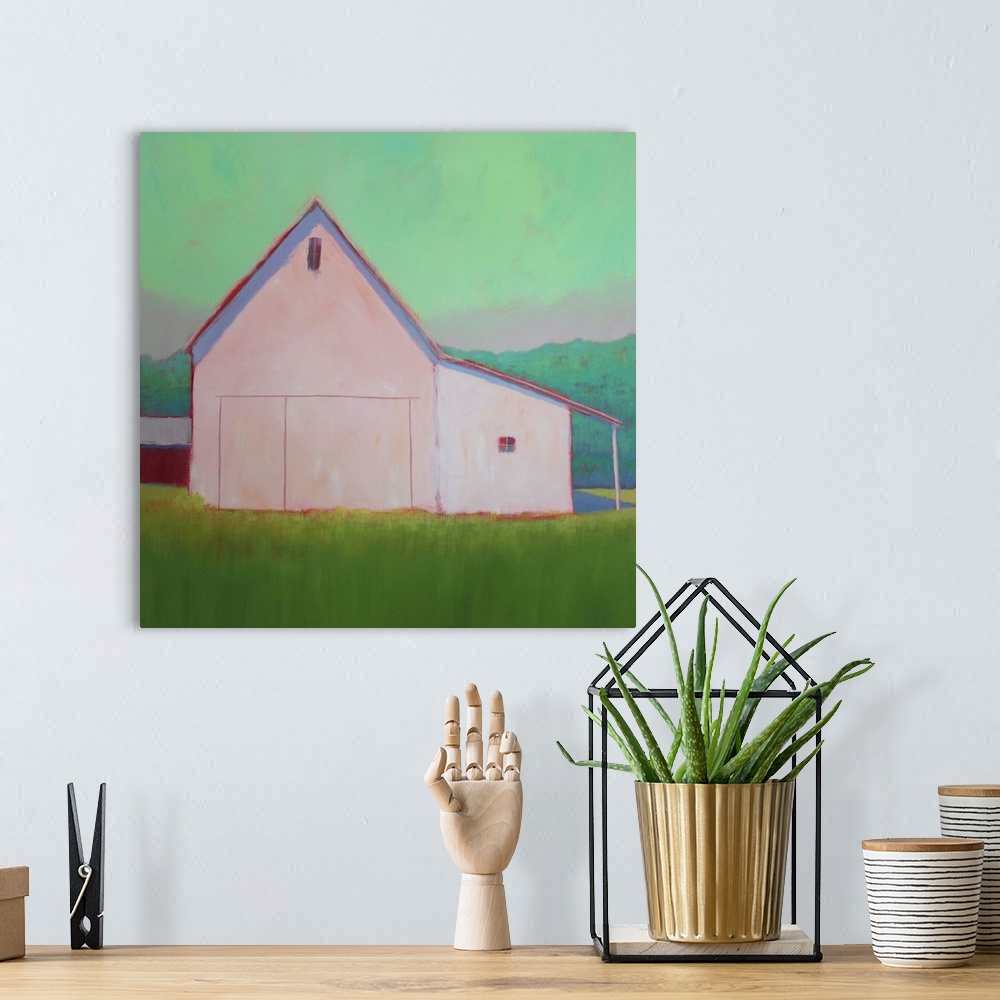 A bohemian room featuring Square artwork of an agricultural building on a green countryside against a bright mint sky.