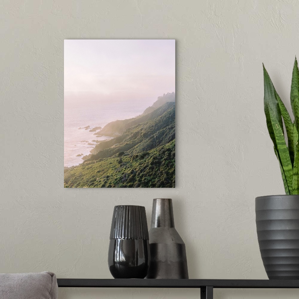 A modern room featuring A hazy photograph of a hilly coastline receding into the distance.
