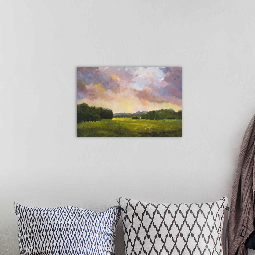 A bohemian room featuring Contemporary painting of a countryside landscape at sunset.
