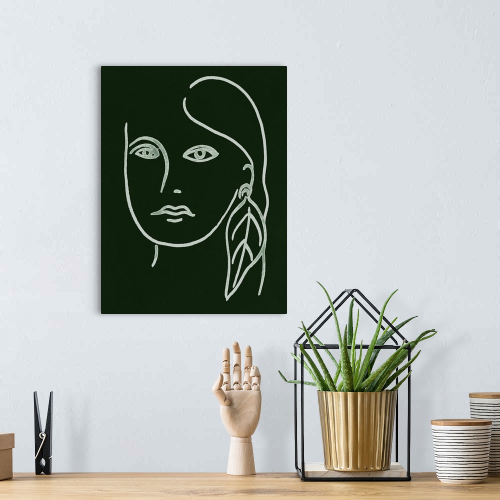 A bohemian room featuring Portrait outline of a woman wearing a feather earring on a dark green background.