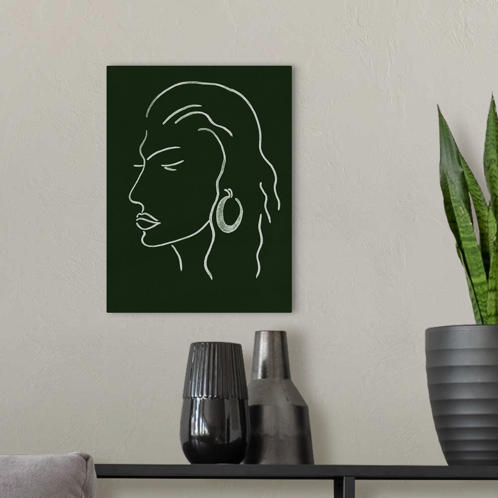 A modern room featuring Portrait outline of a woman wearing a fashionable earring on a dark green background.
