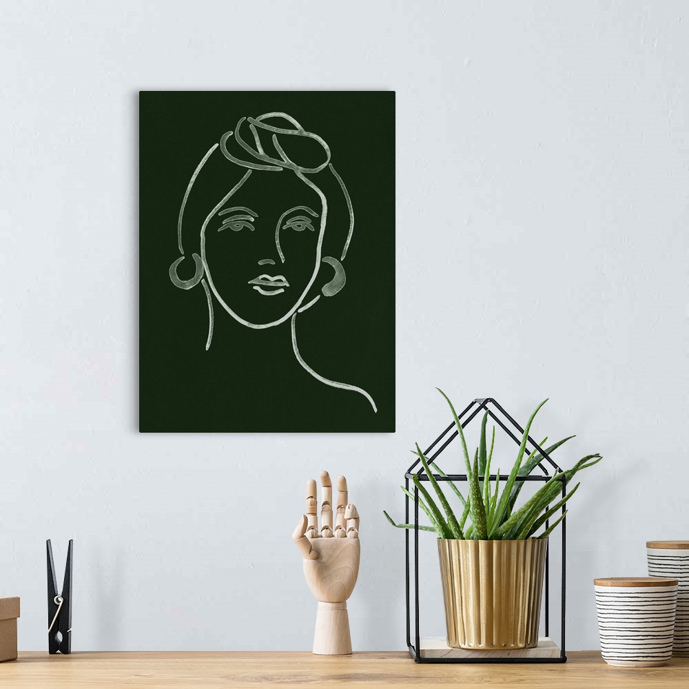 A bohemian room featuring Portrait outline of a woman on a dark green background.