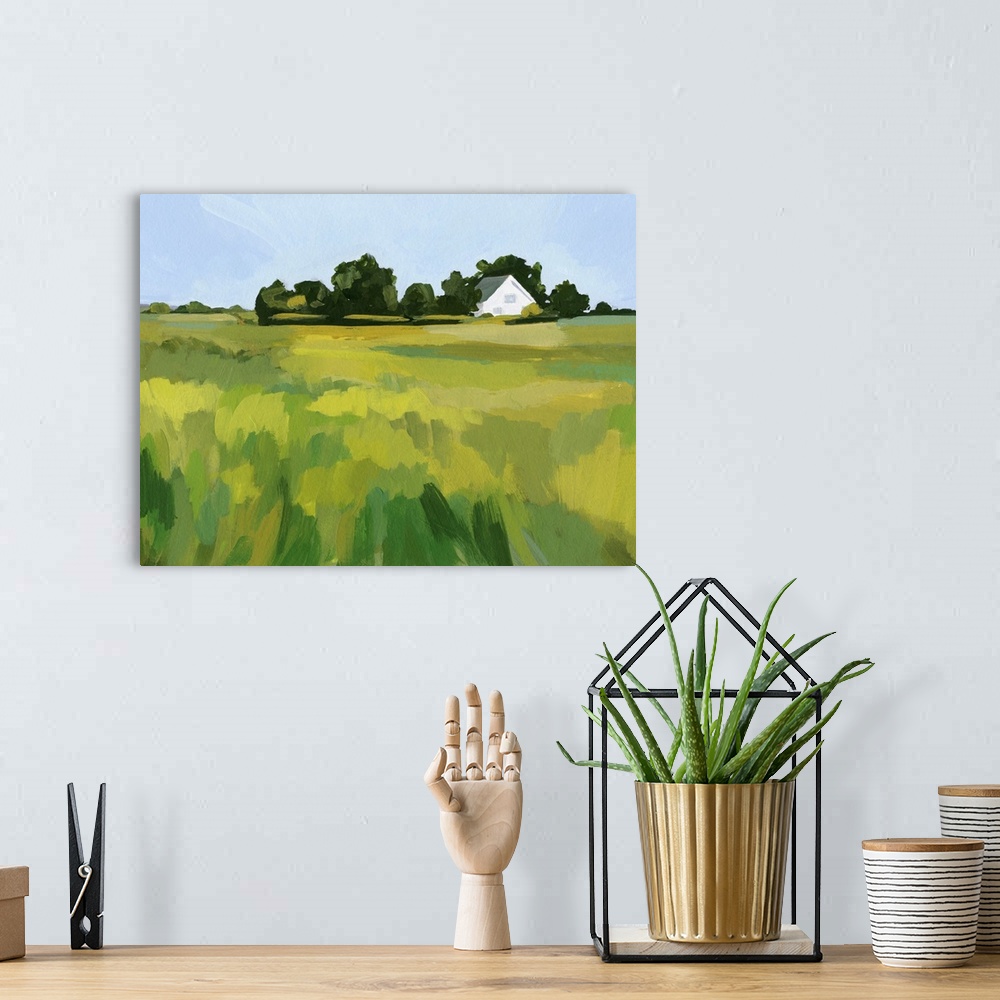 A bohemian room featuring A simple contemporary painting of a field of tall grasses with a white house in the distance. The...
