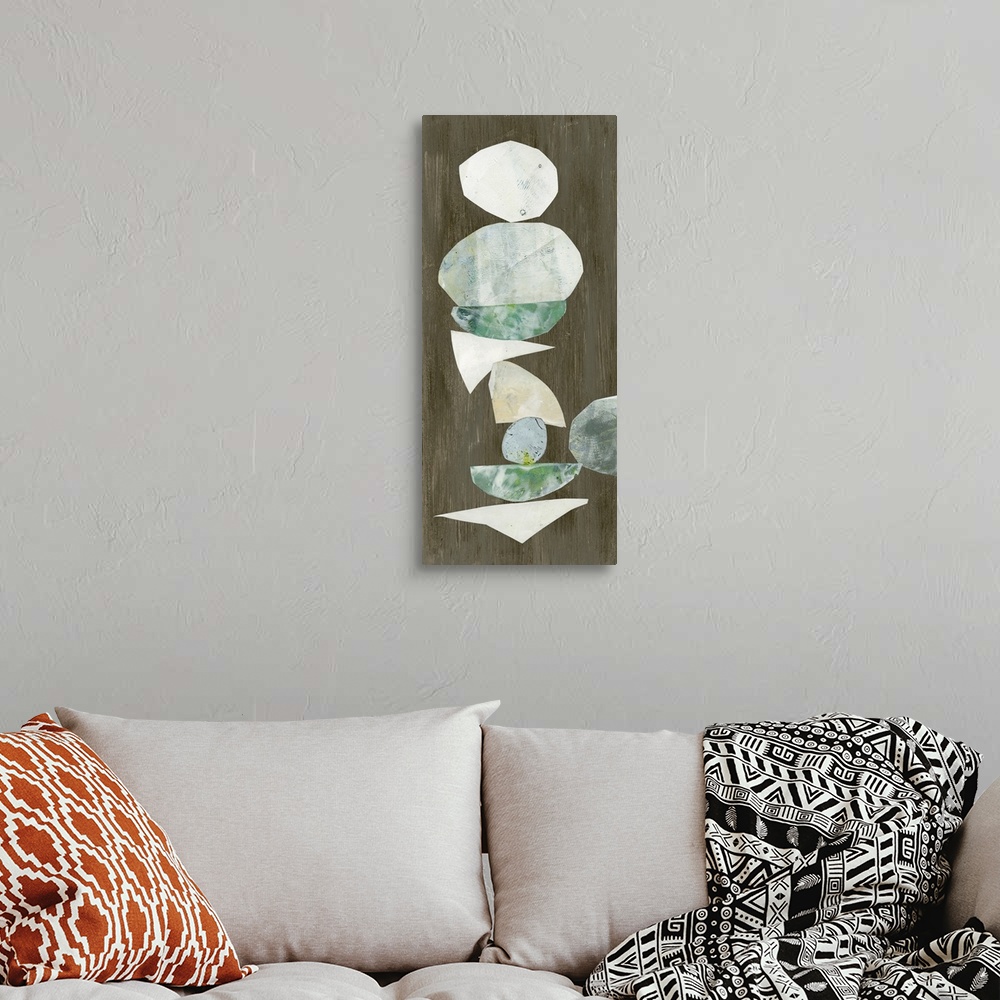 A bohemian room featuring Vertical abstract artwork of organic cut-out shapes on dark brown.
