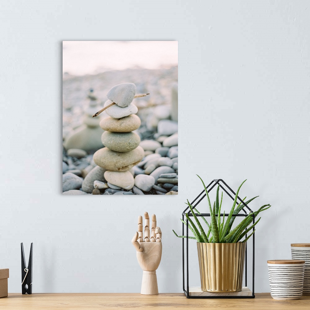 A bohemian room featuring Photograph of stack of small pebbles on the beach, California.