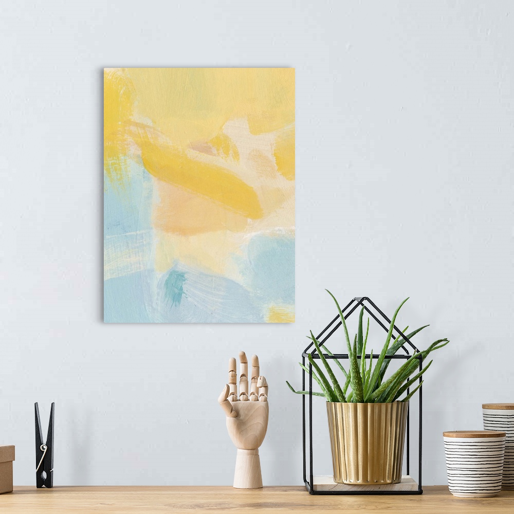 A bohemian room featuring Contemporary abstract art using soft pale yellows and blues mixing together to create depth.