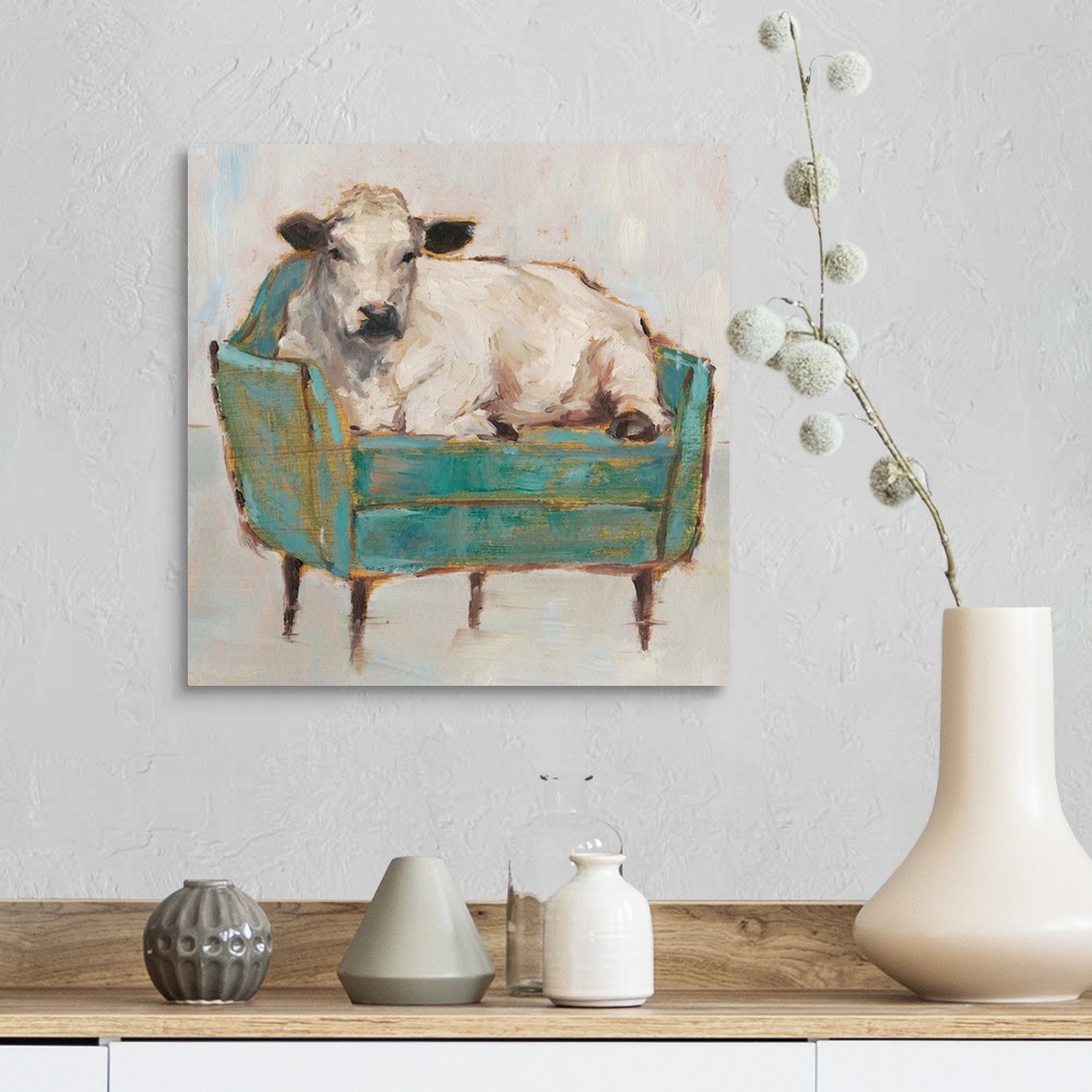 A farmhouse room featuring A whimsical composition of a large white cow lying comfortably on a luxe teal sofa. With it's gol...