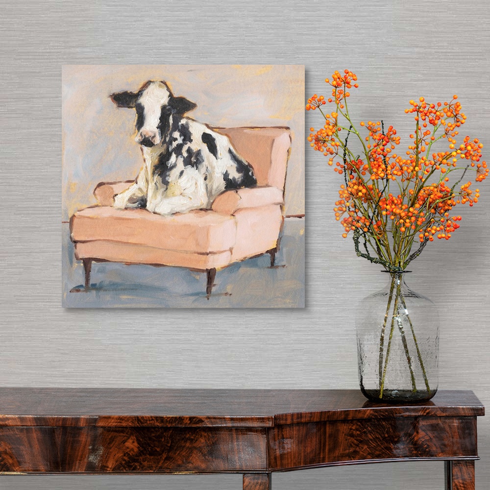 A traditional room featuring A whimsical composition of a large black and white cow lying comfortably on a peach colored chais...