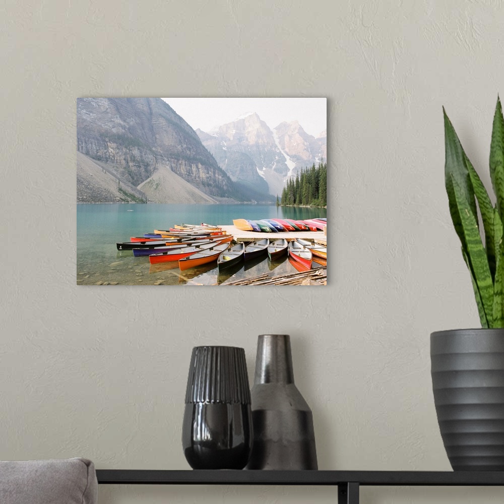 A modern room featuring A photograph of colorful canoes on the edge of Moraine Lake, Banff National Park, Alberta, Canada.