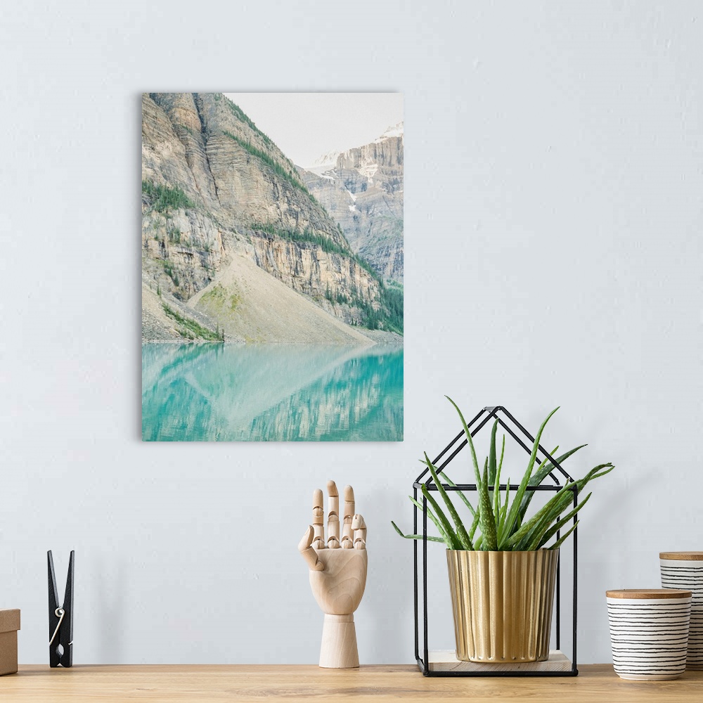 A bohemian room featuring A photograph of mountains reflecting in the clear blue water of Moraine Lake, Banff National Park...