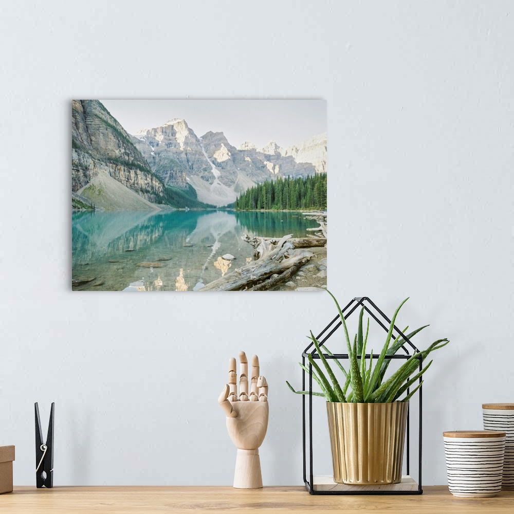 A bohemian room featuring A photograph of mountains reflecting in the clear blue water of Moraine Lake, Banff National Park...