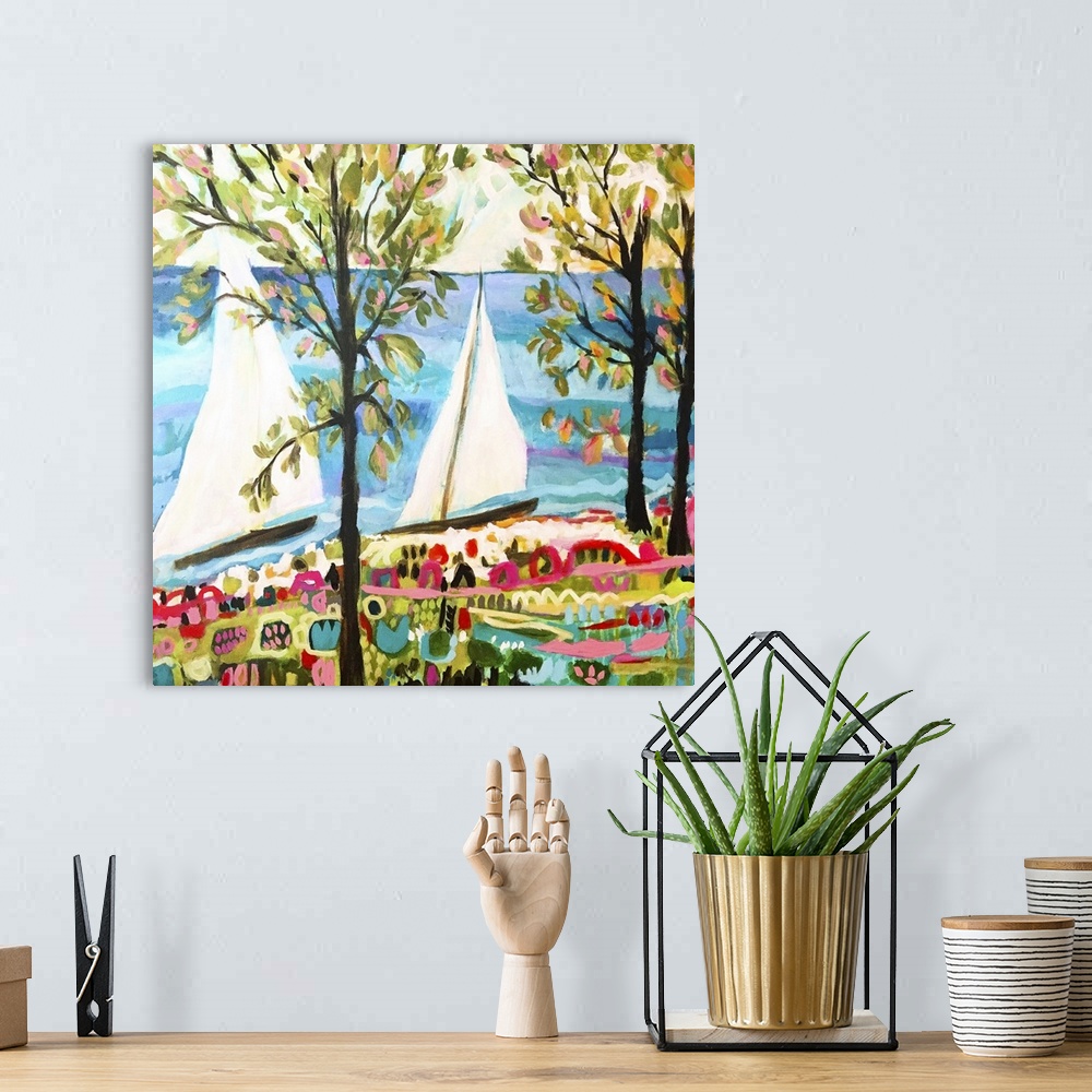 A bohemian room featuring Contemporary artwork of two sailboats on the ocean, seen through the trees.