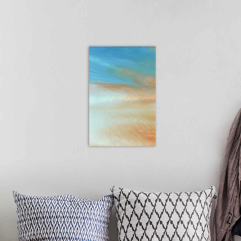 A bohemian room featuring Modern abstract artwork in blue and orange resembling a hazy morning sky.