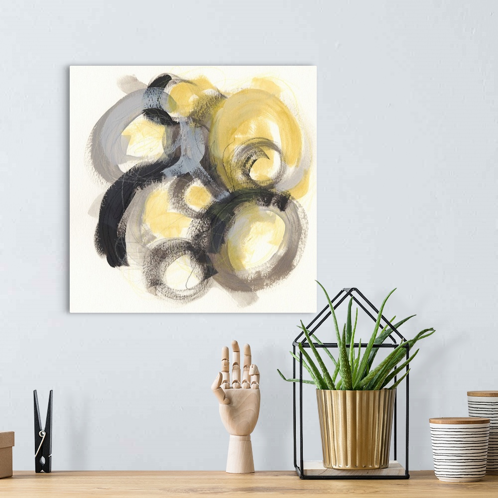A bohemian room featuring Contemporary abstract painting of circles made from broad strokes with a golden center against a ...