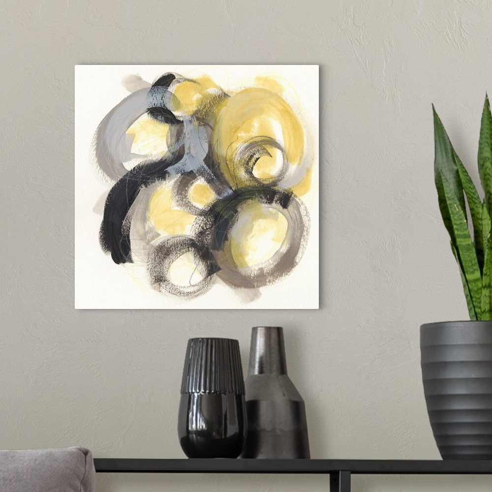 A modern room featuring Contemporary abstract painting of circles made from broad strokes with a golden center against a ...