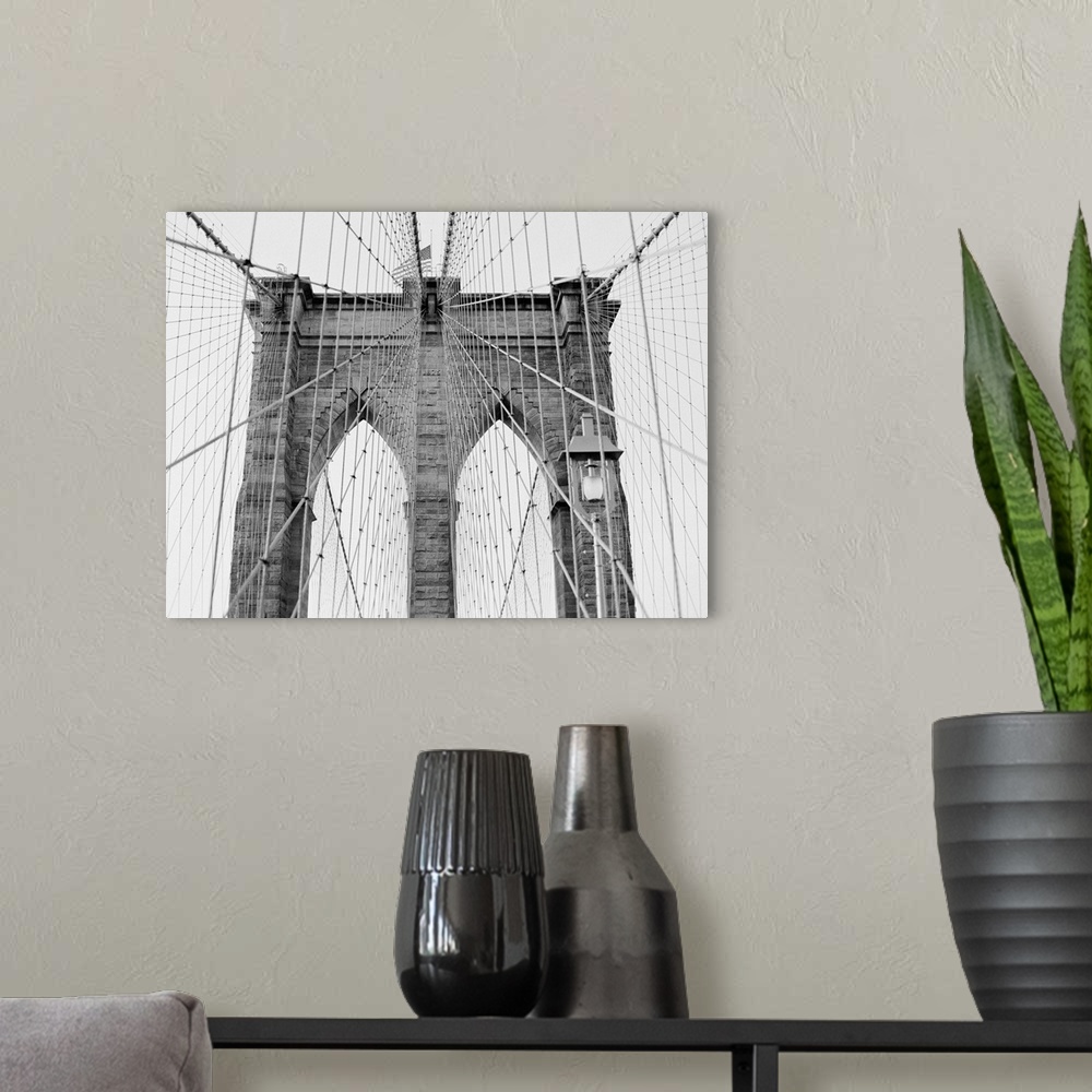 A modern room featuring Black and White architectural photograph of New York's Brooklyn Bridge.