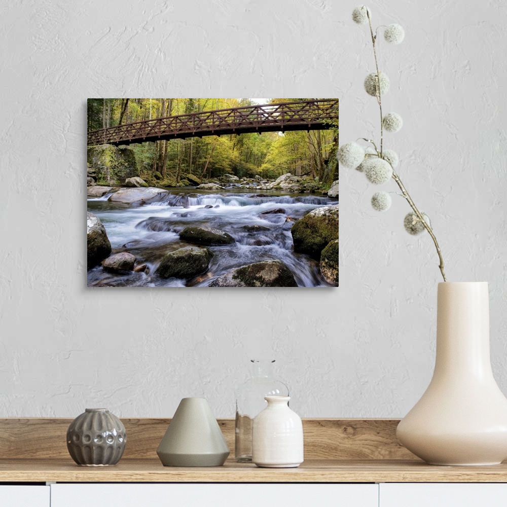 A farmhouse room featuring Photograph of a rushing river flowing under a bridge in a dense forest.