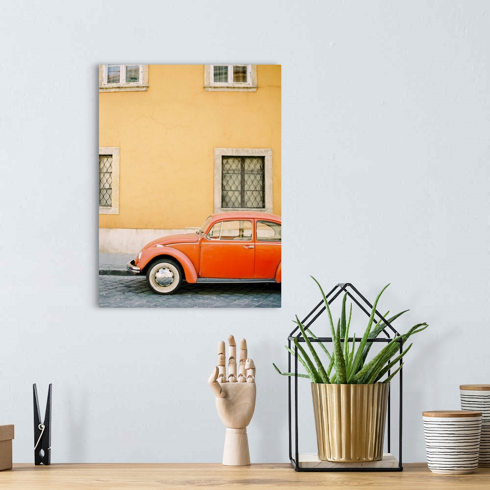 A bohemian room featuring Photograph of an orange Volkswagen Beetle car parked in front of a yellow wall, Budapest, Hungary.