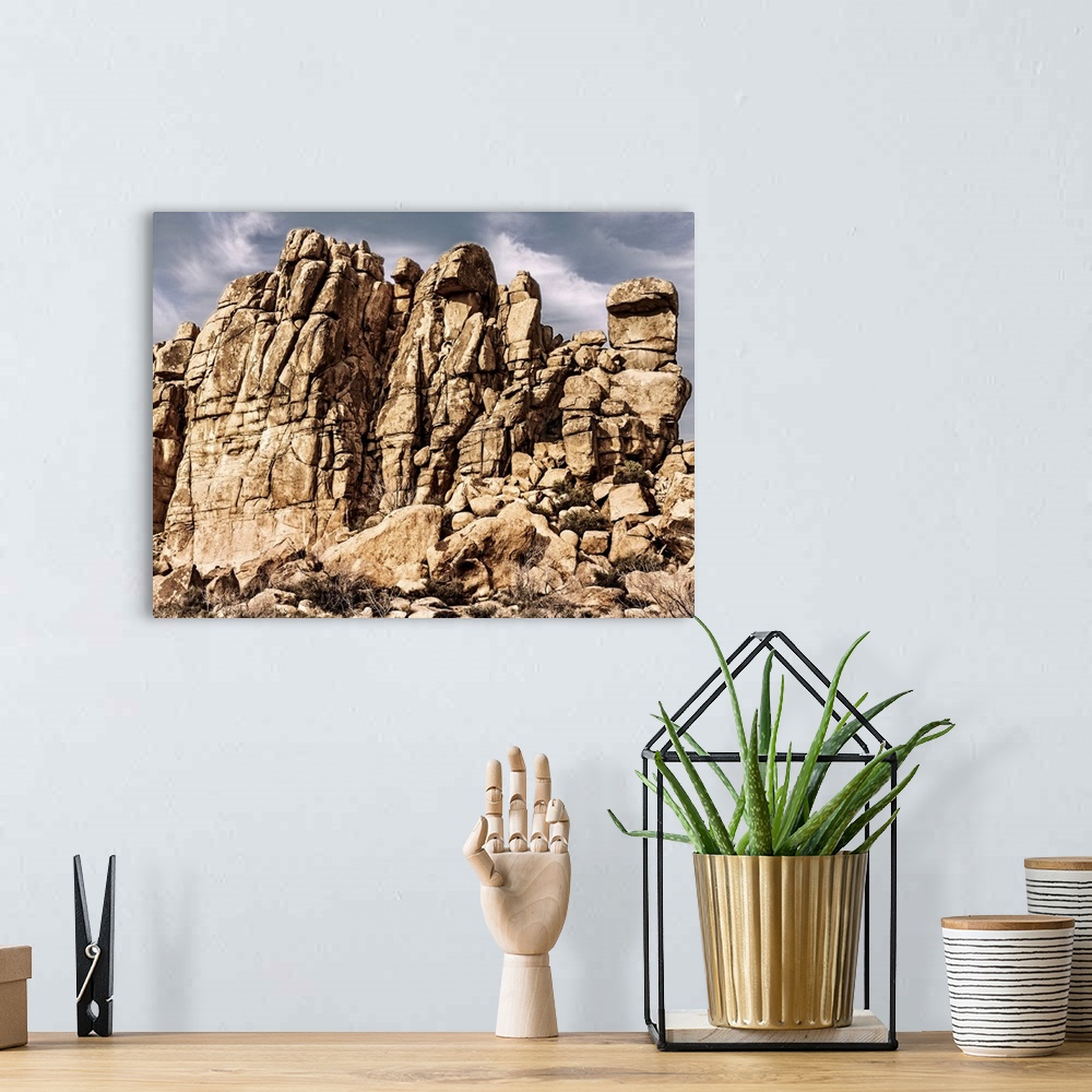 A bohemian room featuring Rocky desert cliff under a cloudy sky on a sunny day.