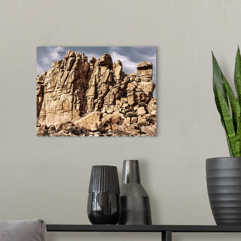 A modern room featuring Rocky desert cliff under a cloudy sky on a sunny day.