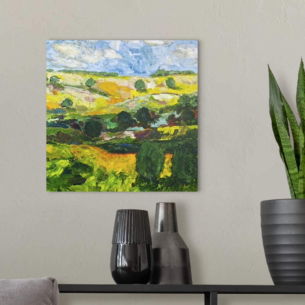 A modern room featuring Contemporary painting of a country landscape with trees along the edges of the rolling hills.