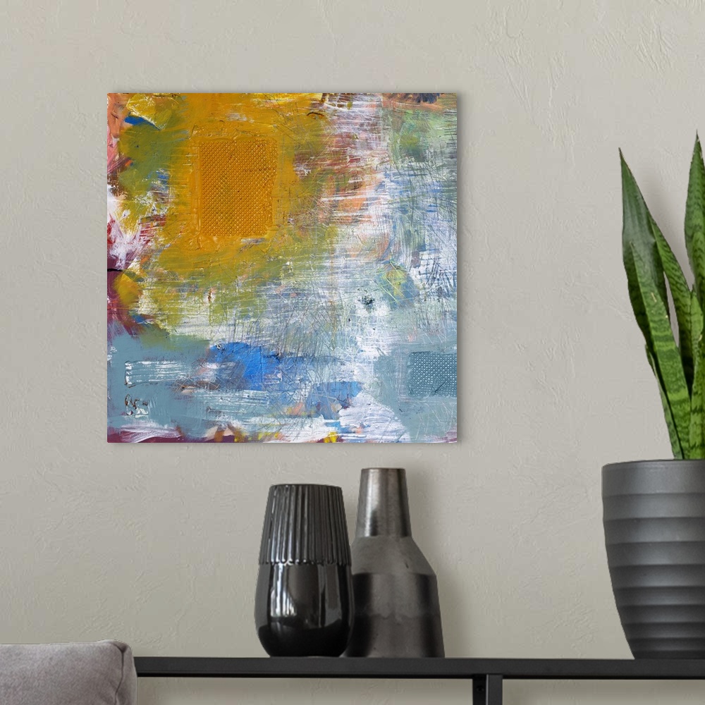 A modern room featuring Abstract artwork of a multitude of vibrant and pale colors colliding with one another.